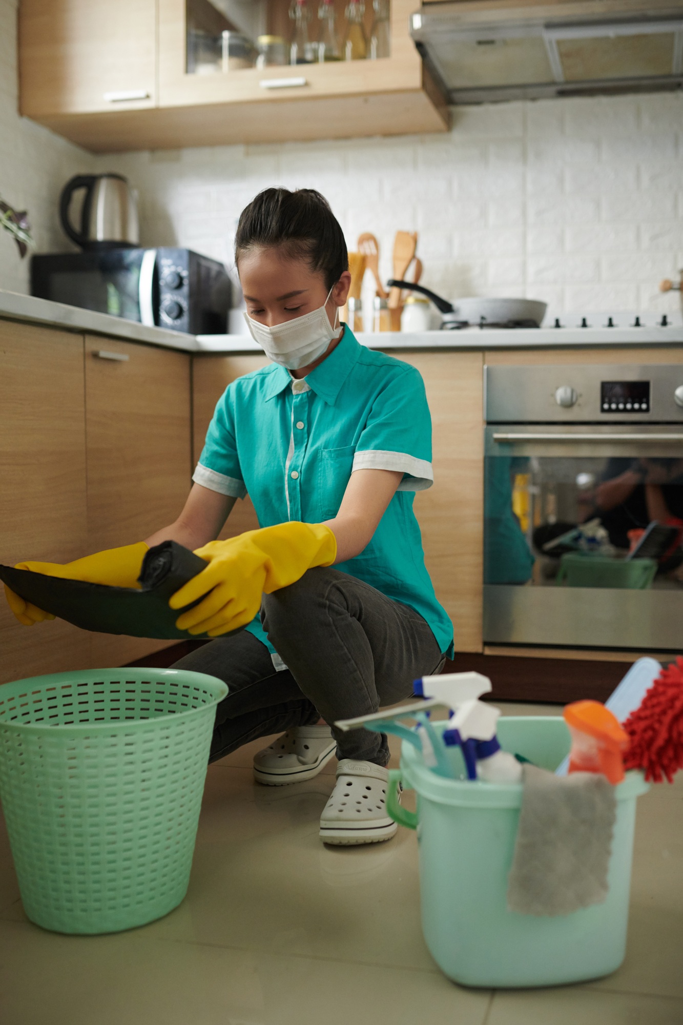 Asian cleaning worker working in kitchen