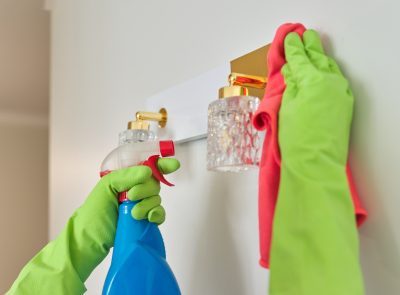 House cleaning, close-up of hands cleaning and polishing lamp