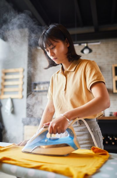 Young Woman Ironing Clothes